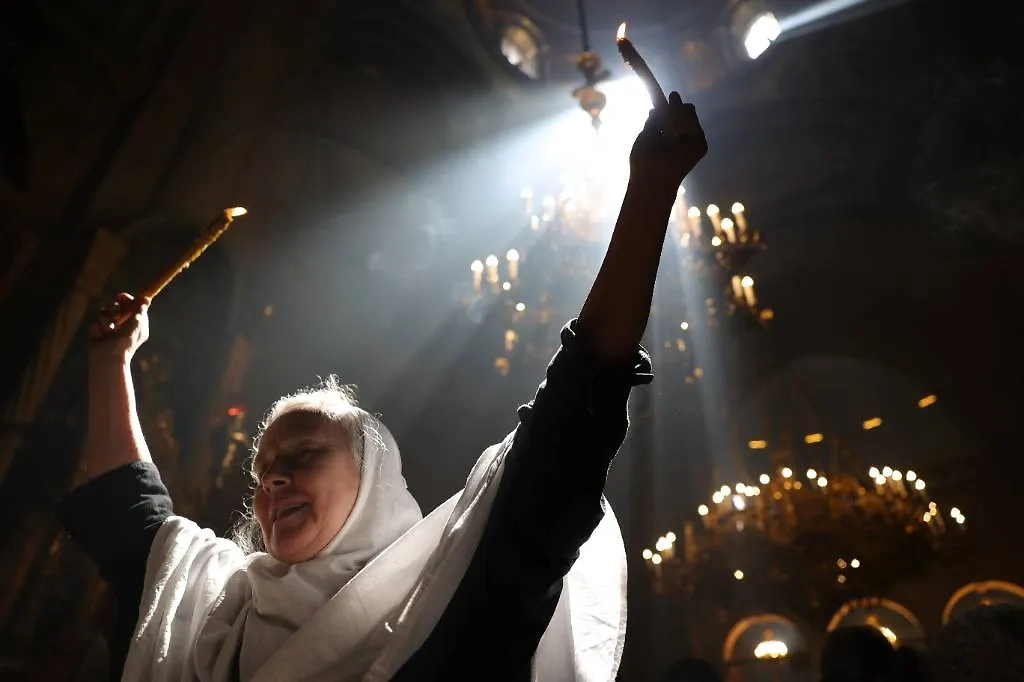 Благодатный огонь — волшебство ли это или холодная наука? Фото © ТАСС / EPA / ABIR SULTAN